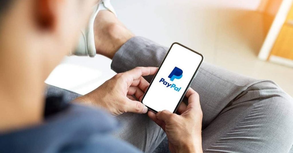 мужчина оплачивает хостинг сайта через PayPal